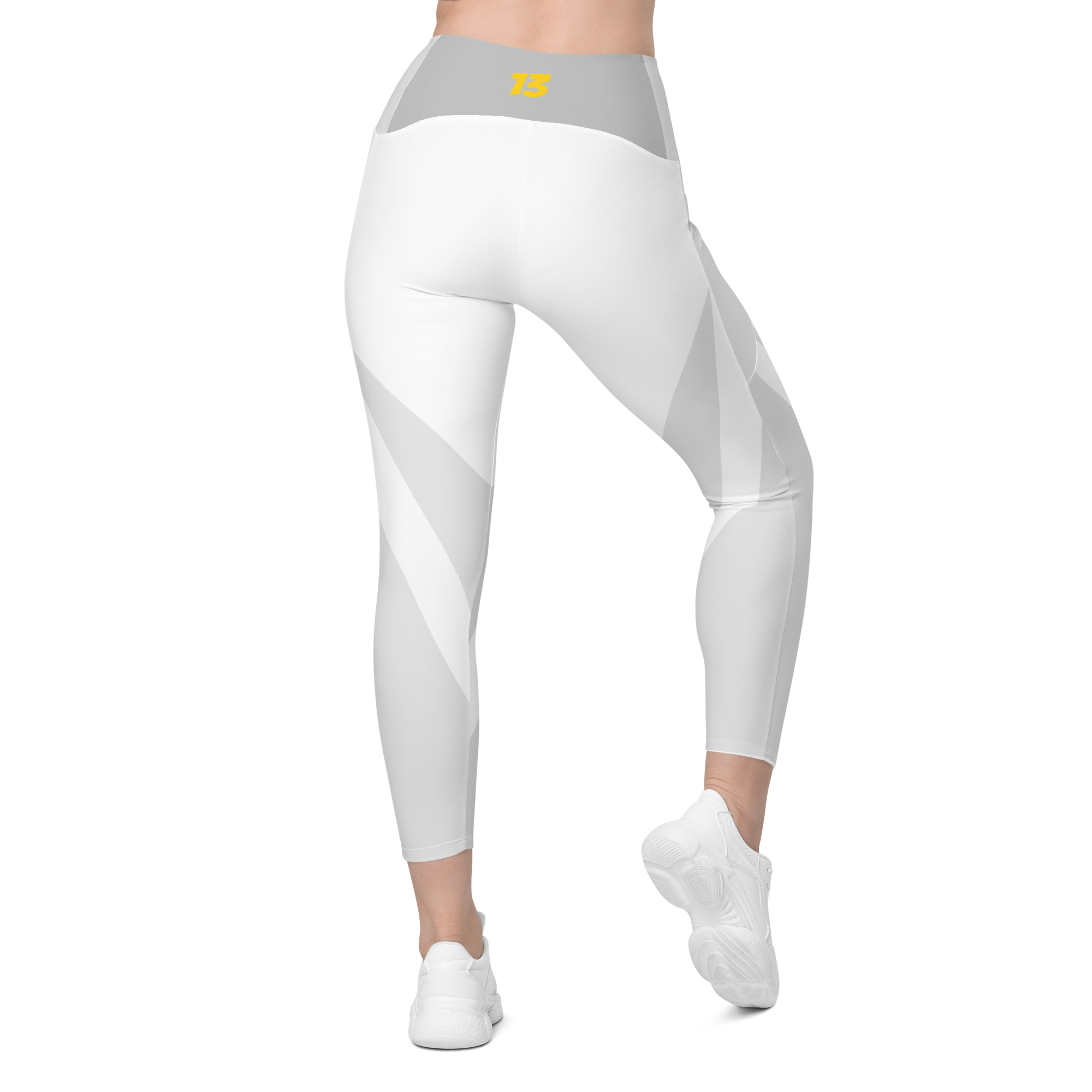 Back side profile of Clarity leggings highlighting the integrated utility pocket and signature '13' hallmark