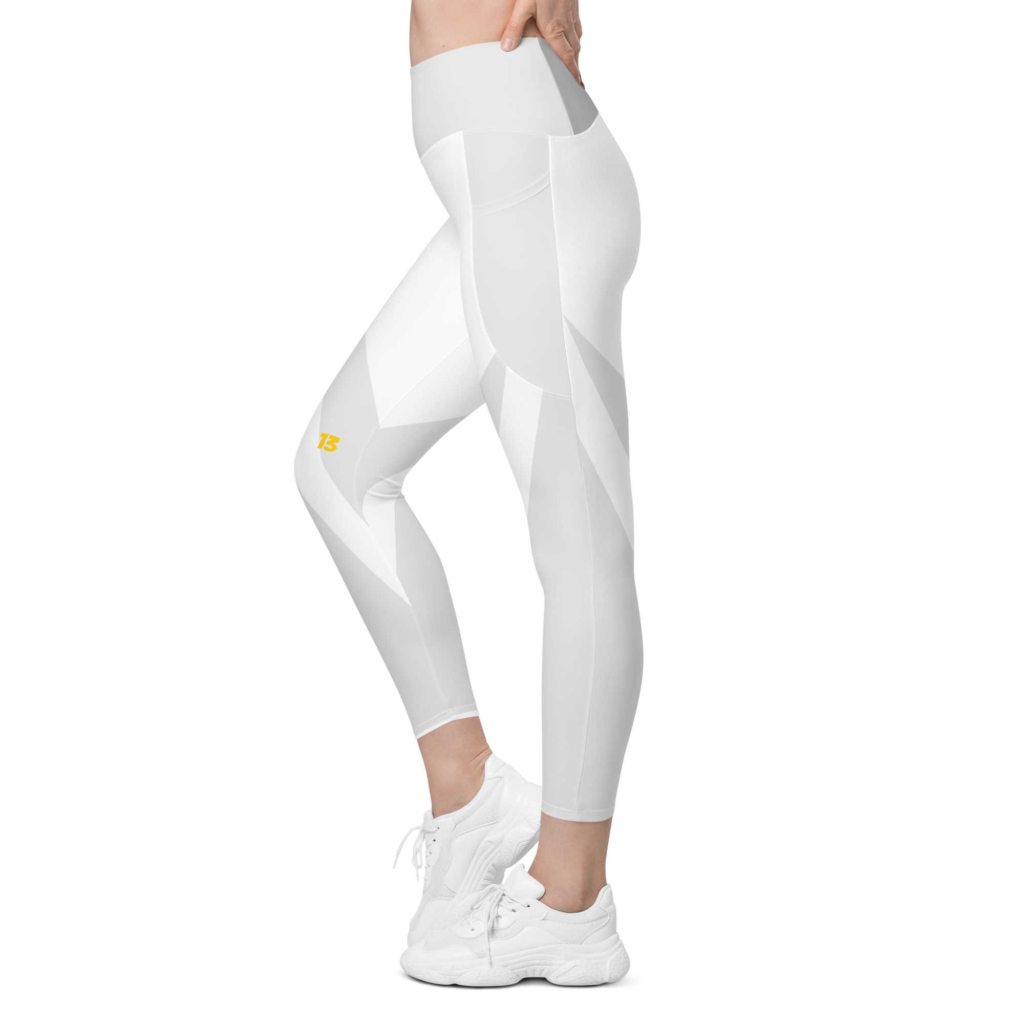 Left side profile of Clarity leggings highlighting the integrated utility pocket and signature '13' hallmark